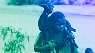 A child carries a goat on her shoulders through a flooded river caused by last week's heavy rains caused by Tropical Cyclone Freddy in Phalombe, southern Malawi, March 2023