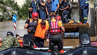 Locals are evacuated on an excavator from a flooded area, in the aftermath of Storm Daniel, in Larissa, Greece.
