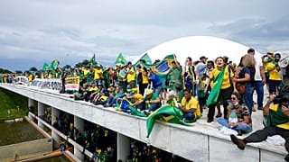 Protesters, supporters of Brazil's former President Jair Bolsonaro, stand on the roof of the National Congress building after they stormed it, in Brasilia, Brazil, Sunday, Jan