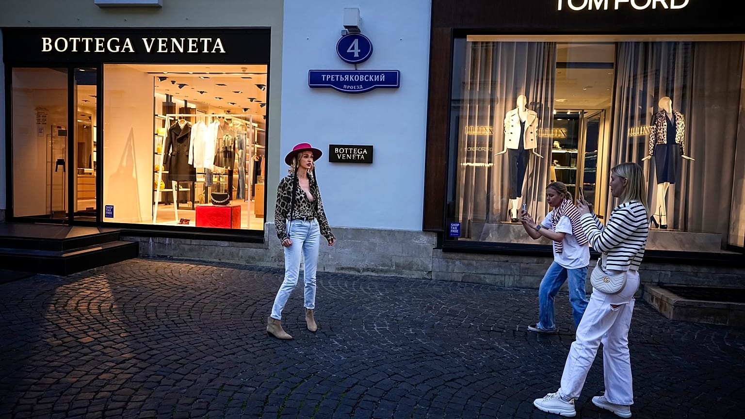 FILE - A Moscow fashionista poses in a street of expensive boutiques not far from Red Square in Moscow, Russia, Monday, Aug. 21, 2023.