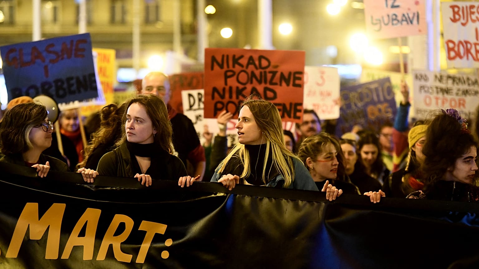 Women march behind a banner during a rally to mark the International Women's Day in Zagreb on March 8, 2023.