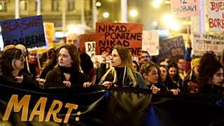 Women march behind a banner during a rally to mark the International Women's Day in Zagreb on March 8, 2023.