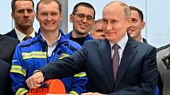 Russian President Vladimir Putin, foreground right, attends the launch ceremony for the first technological line for liquefying natural gas on gravity bases, July 20, 2023