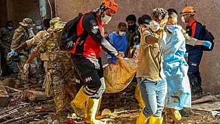 In this photo provided by Turkey's IHH humanitarian aid group, rescuers retrieve the body of a flooding victim in Derna, Libya, Wednesday, Sept.13, 2023.