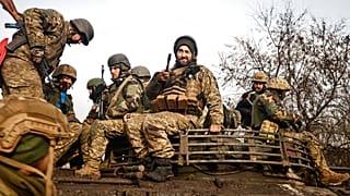 Ukrainian servicemen take positions on the frontline at an undisclosed location in the Donetsk region, Ukraine, Friday, Nov. 24, 2022. 