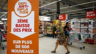 A sign reading "Anti-inflation challenge, third price cut on more than 500 new products" at a Carrefour supermarket near Paris, 13 September 2023