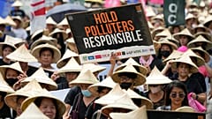 Protesters hold slogans as they join the global march to end fossil fuel on 15 September 2023, in Quezon city, Philippines. 