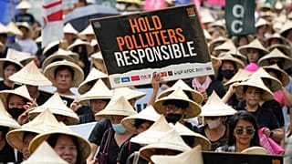Protesters hold slogans as they join the global march to end fossil fuel on 15 September 2023, in Quezon city, Philippines.