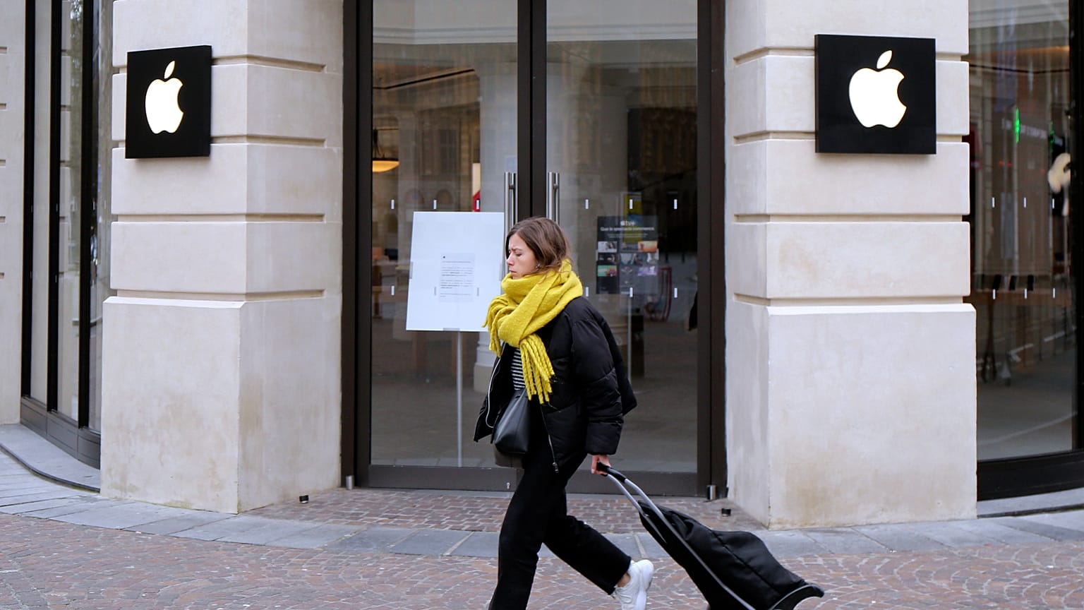 A woman walks past a closed Apple Store in Lille, northern France, 16 March 2020.