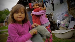 Roma children hug each other in the village of Kallo, Hungary, Sunday, Oct. 11, 2020.