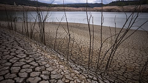 Cracked earth is visible at the Sau reservoir north of Barcelona, Spain, April 18, 2023. 
