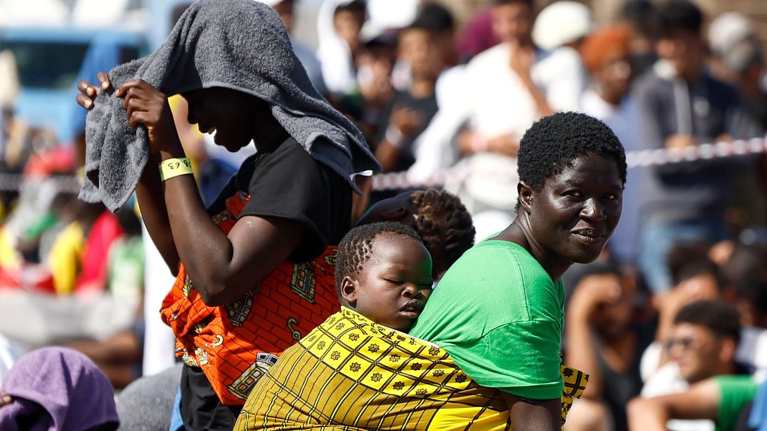 Migrants wait to be transferred from the Lampedusa Island to the mainland, Friday, Sept. 15, 2023.