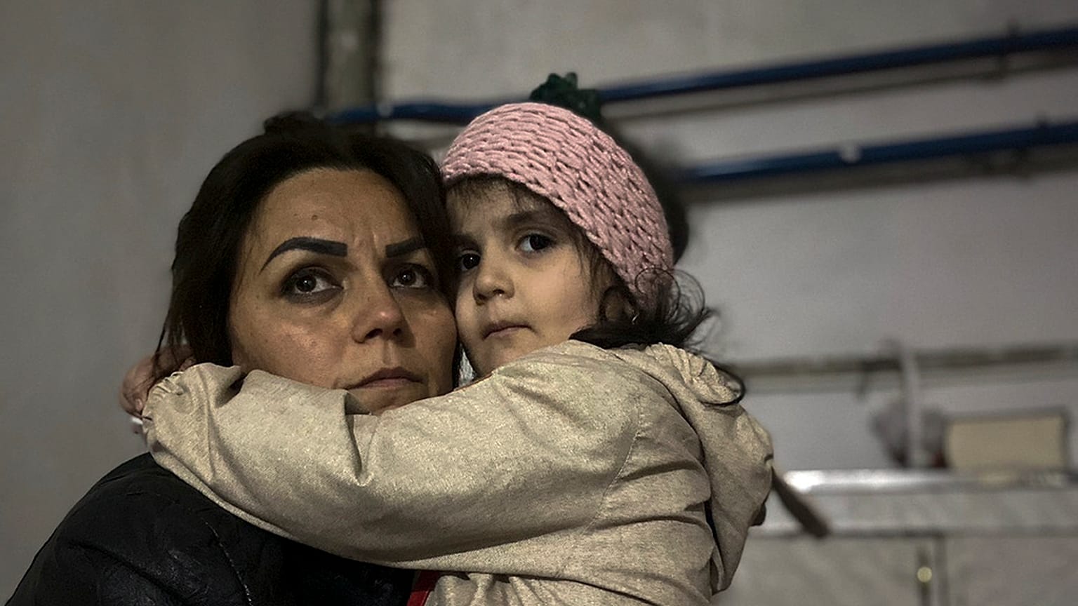 A girl embraces her relative sitting in a shelter during shelling in Stepanakert, Nagorno-Karabakh. Azerbaijan on Tuesday, Sept. 19, 2023.