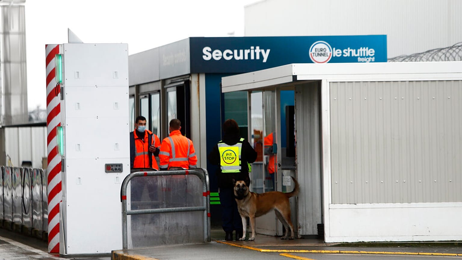FILE - Custom officers stand at the check point on the Eurotunnel site, meters before the tunnel linking France to Britain, in Coquelles, northern France