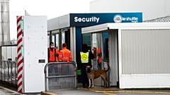 FILE - Custom officers stand at the check point on the Eurotunnel site, meters before the tunnel linking France to Britain, in Coquelles, northern France