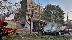 emergency services personnel work to extinguish a fire following a Russian attack in Cherkasy, Ukraine, Thursday, Sept. 21, 2023. 