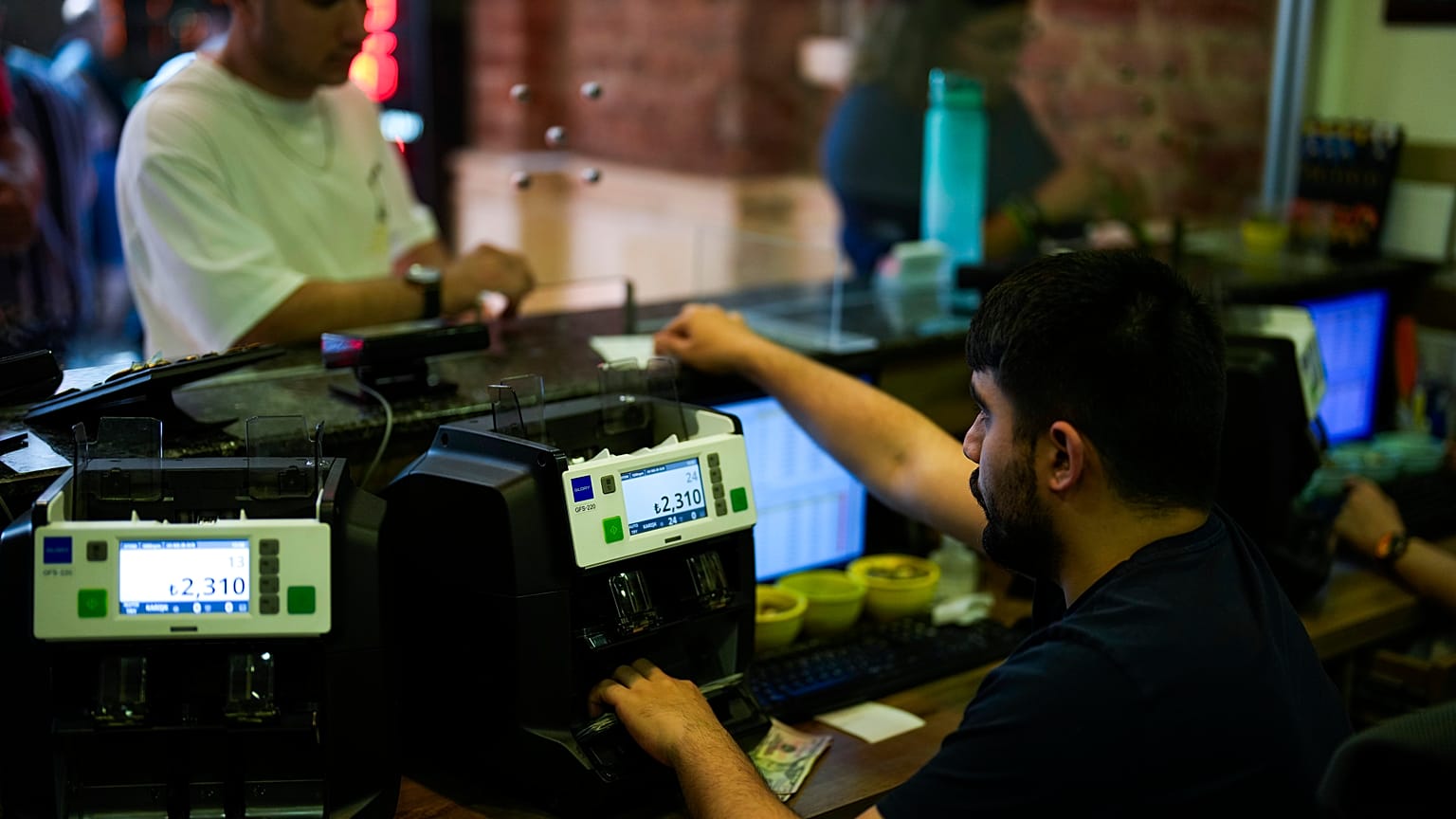 A worker counts Turkish liras banknotes in an exchange currency shop in Istanbul, Turkey, Tuesday, June 20, 2023.