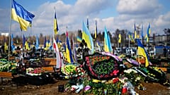 FILE - The grave of Yana Rikhlitska, 29, a Ukrainian army as a medic killed in the Bakhmut area, during the funeral in Vinnytsia, Ukraine, Tuesday, March 7, 2023.