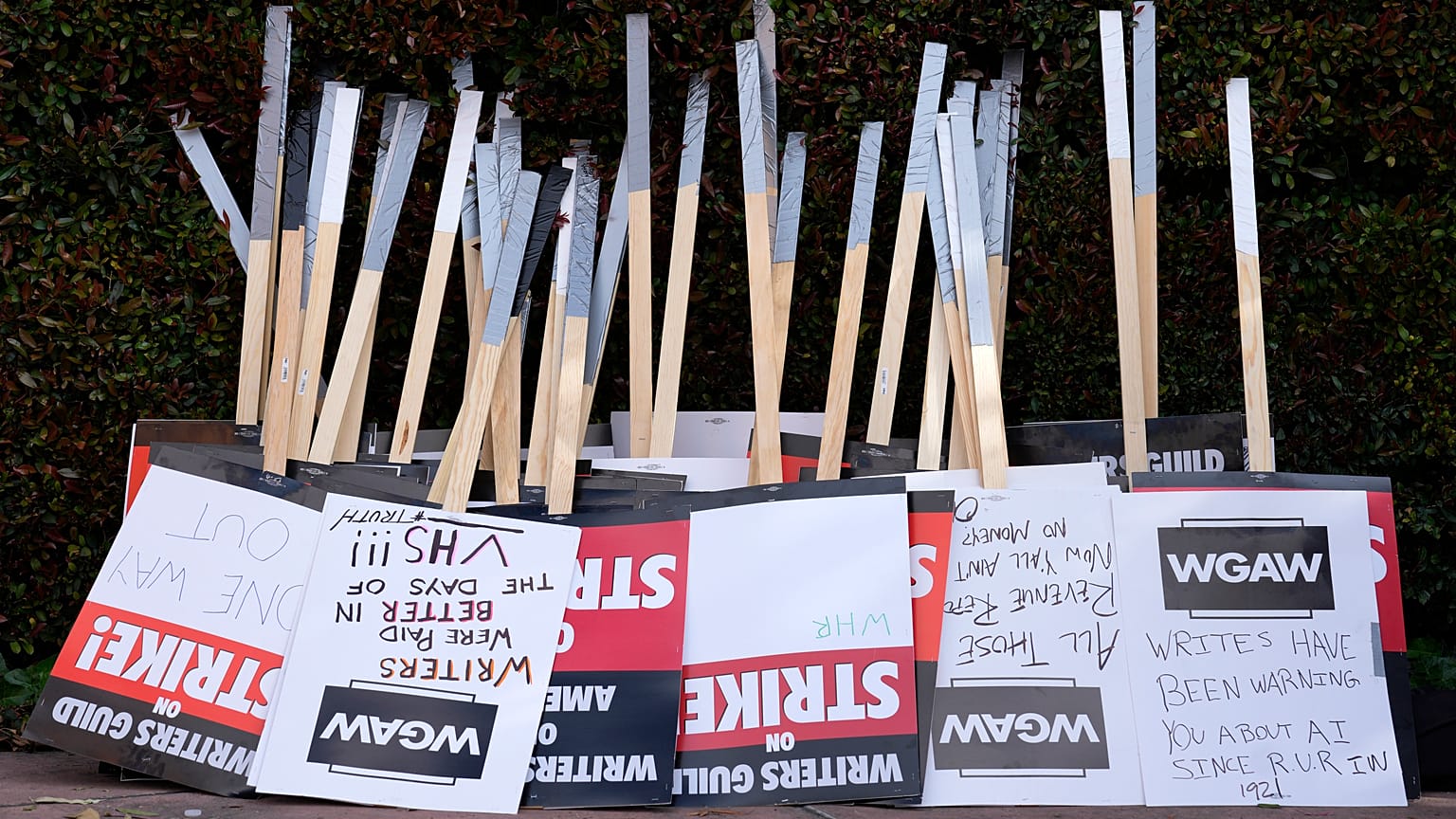 Placards are gathered together at the close of a picket by members of The Writers Guild of America outside Walt Disney Studios