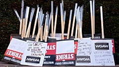 Placards are gathered together at the close of a picket by members of The Writers Guild of America outside Walt Disney Studios