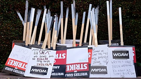 Placards are gathered together at the close of a picket by members of The Writers Guild of America outside Walt Disney Studios