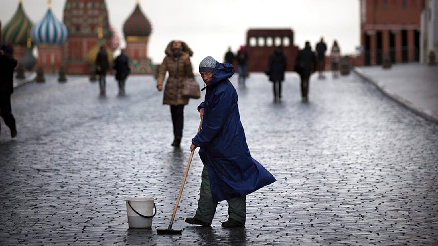 FILE - A street worker cleans paving stones in Red Square in Moscow, Russia, Tuesday, Dec. 22, 2015. 
