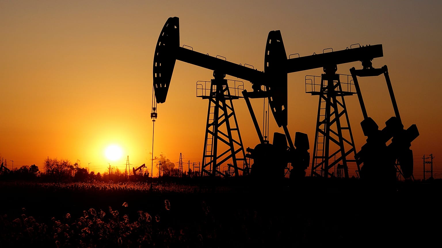 Pumpjacks are seen against the setting sun at the Daqing oil field in Heilongjiang province, China December 7, 2018. 