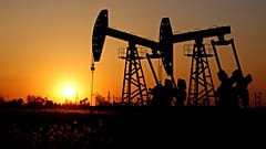 Pumpjacks are seen against the setting sun at the Daqing oil field in Heilongjiang province, China December 7, 2018. 