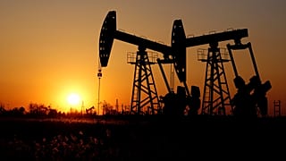 Pumpjacks are seen against the setting sun at the Daqing oil field in Heilongjiang province, China December 7, 2018. 