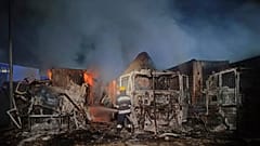 In this photo provided by regional authorities, firefighters work to extinguish a fire at a site of a Russian attack near the seaport in Odesa, Ukraine.