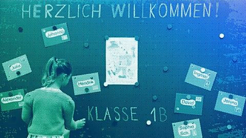 A first-grader takes her name tag off the blackboard during the first lesson in a classroom at a school in Eichenau, September 2008