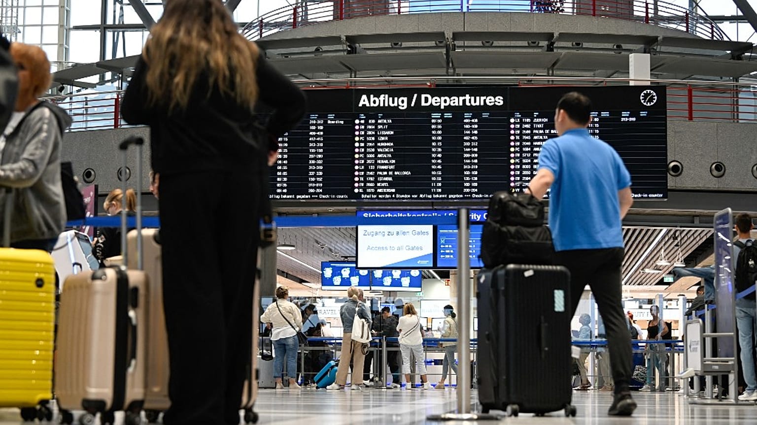 Passengers queue for check-in at counters at Stuttgart Airport in July 2023. Check-in desks are usually where people learn that their seat has been overbooked.