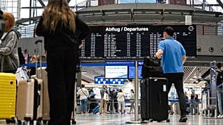 Passengers queue for check-in at counters at Stuttgart Airport in July 2023. Check-in desks are usually where people learn that their seat has been overbooked.