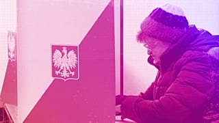 A woman reads her ballot before casting during general elections in Warsaw, October 2015