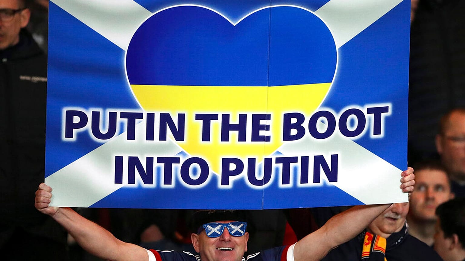 Football supporters show their support to Ukraine during an international soccer match between Scotland and Poland at Hampden Park stadium in Scotland, March 24 2022.