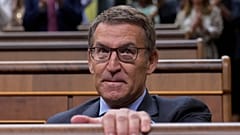 The leader of Spain's conservatives Alberto Feijoo leaves an investiture session at the Spanish parliament in Madrid.
