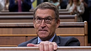 The leader of Spain's conservatives Alberto Feijoo leaves an investiture session at the Spanish parliament in Madrid.