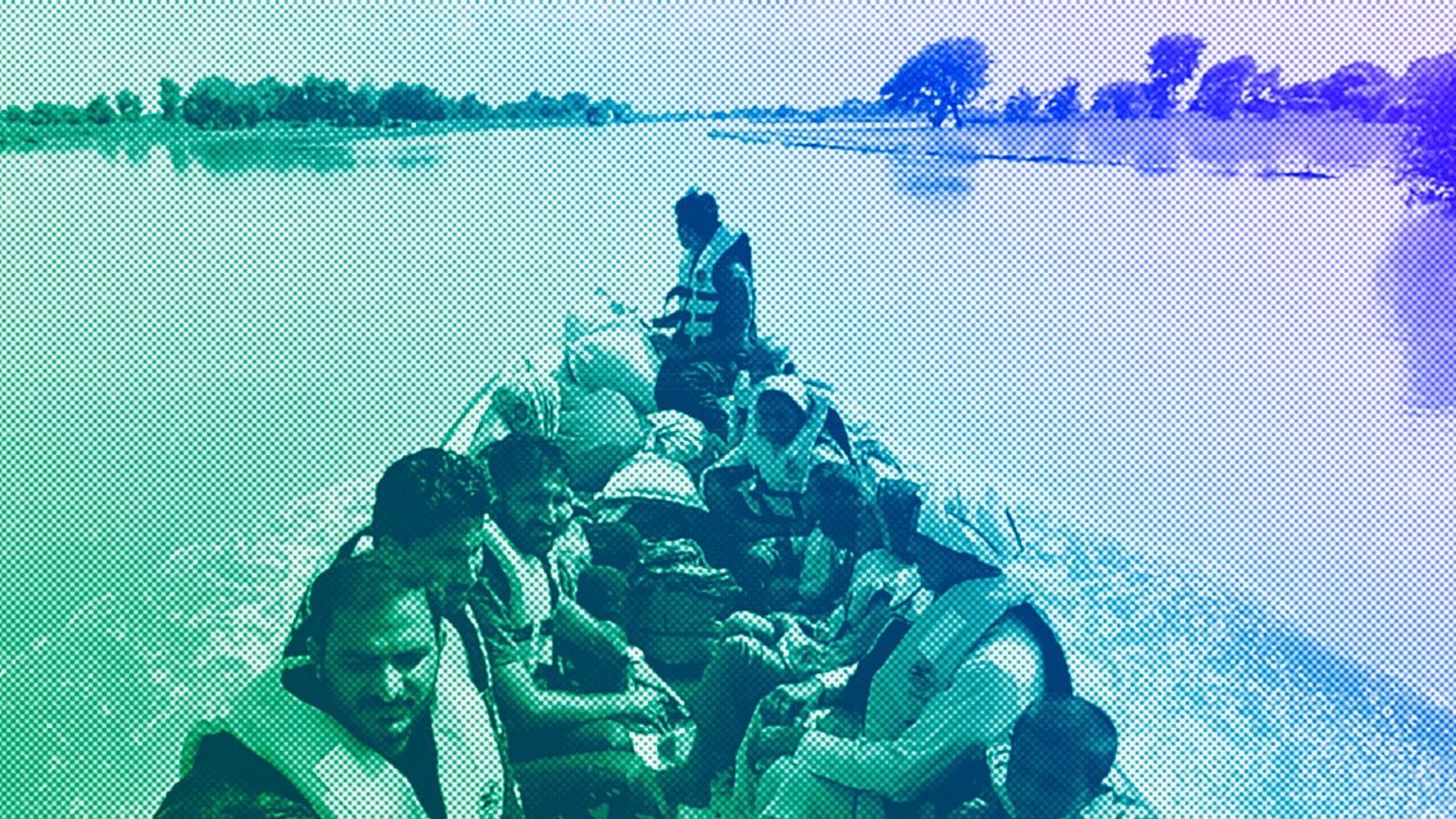 Rescue workers use a boat to evacuate villagers from a flooded area of Bahawalnagar district in Pakistan's Punjab province, August 2023