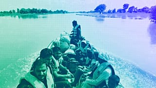 Rescue workers use a boat to evacuate villagers from a flooded area of Bahawalnagar district in Pakistan's Punjab province, August 2023