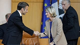 Emmanuel Macron shakes hands with the President of the Corsican Assembly Marie-Antoinette Maupertuis before addressing a session of the Corsican Assembly in Ajaccio.