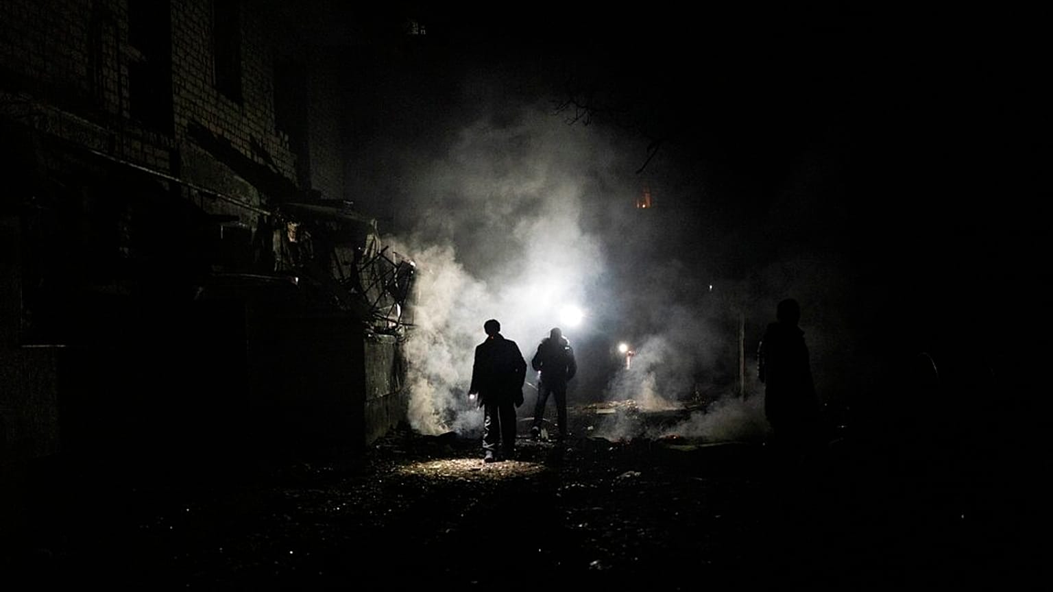 FILE - Resident walks amid debris after a Russian attack in Kherson, southern Ukraine, Nov. 24, 2022. 