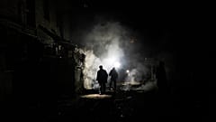 FILE - Resident walks amid debris after a Russian attack in Kherson, southern Ukraine, Nov. 24, 2022. 