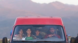 Ethnic Armenians from Nagorno-Karabakh sit inside a minibus on their way to Armenia's Goris in Syunik region, Armenia, on Thursday, Sept. 28, 2023.