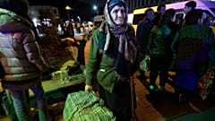 An ethnic Armenian woman from Nagorno-Karabakh carries her suitcase to a tent camp after arriving to Armenia's Goris in Syunik region, Armenia, late on Friday