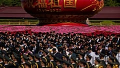 Participants bow to pay respects to the People's Heroes Monument during a ceremony to mark Martyr's Day at Tiananmen Square in Beijing, Saturday, Sept. 30, 2023.
