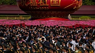 Participants bow to pay respects to the People's Heroes Monument during a ceremony to mark Martyr's Day at Tiananmen Square in Beijing, Saturday, Sept. 30, 2023.
