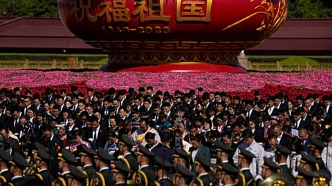 Participants bow to pay respects to the People's Heroes Monument during a ceremony to mark Martyr's Day at Tiananmen Square in Beijing, Saturday, Sept. 30, 2023.