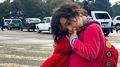 A child holds a toy as people hoping to leave Nagorno-Karabakh gather in the city of Stepanakert/Khankendi on September 26