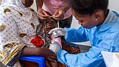A child receives a vaccine against malaria.