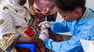 A child receives a vaccine against malaria.
